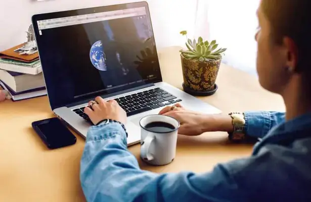 stylish-girl-with-coffee-on-background-of-laptop